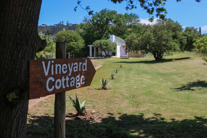 The Vineyard Cottage signpost on the lawn