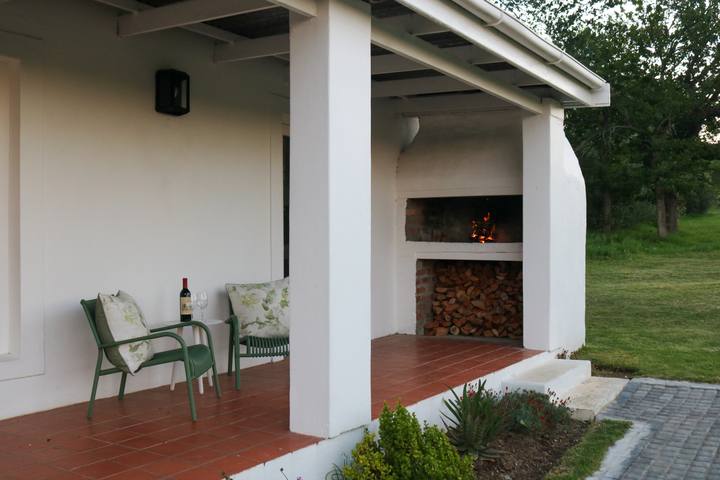 Covered braai patio with a fireplace