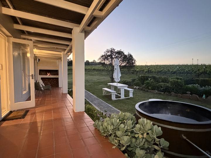 Covered patio and hot tub at dusk