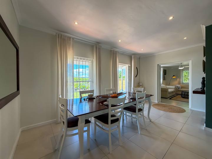 The dining table set for a meal, looking through to the lounge