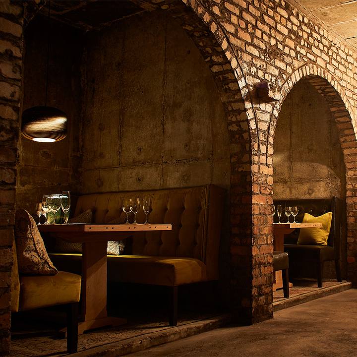 Booth seating in the brick cellar archways