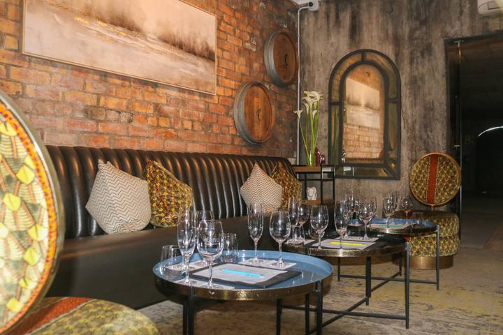 Leather banquettes and tasting tables in the brick cellar